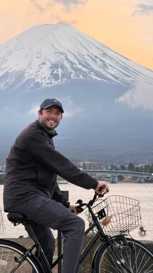 Photo: a man on a bicycle in front of Mount Fuji at sunset